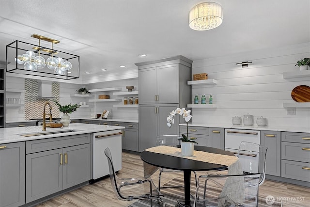 31632 19th Dr NW, Stanwood, WA 98292 - kitchen with open shelves, gray cabinetry, light wood finished floors, a chandelier, and hanging light fixtures