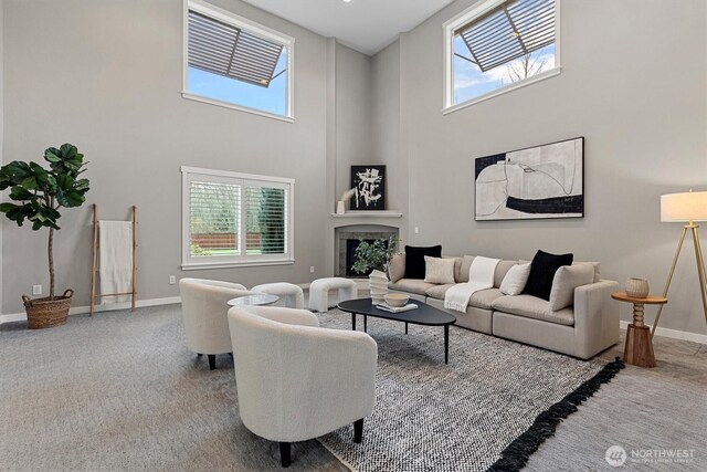 31632 19th Dr NW, Stanwood, WA 98292 - carpeted living area featuring plenty of natural light, a fireplace, a high ceiling, and baseboards