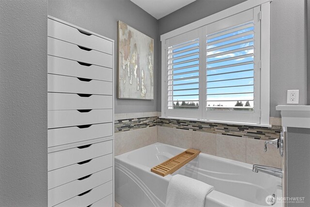 31632 19th Dr NW, Stanwood, WA 98292 - bathroom featuring a garden tub, vanity, and a textured wall