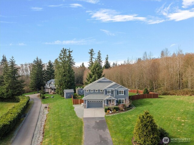 31632 19th Dr NW, Stanwood, WA 98292 - traditional-style home with driveway, an attached garage, and a view of trees