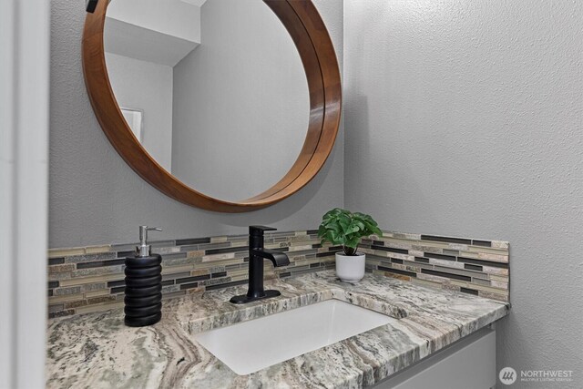 31632 19th Dr NW, Stanwood, WA 98292 - bathroom featuring vanity and tasteful backsplash