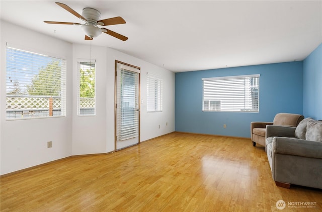 730 SE 8th Ave Unit B101, Oak Harbor, WA 98277 - living room with light wood-style floors, ceiling fan, and baseboards