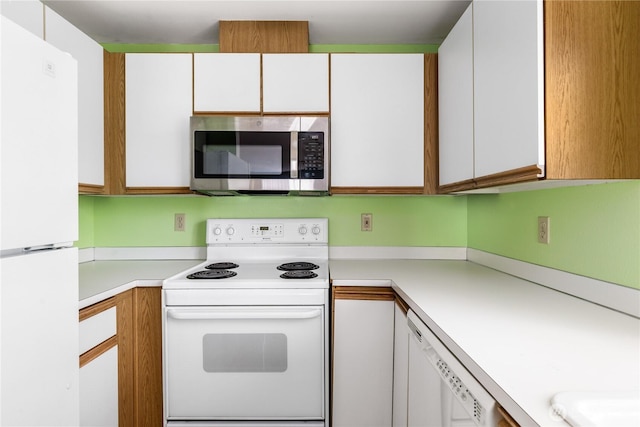 730 SE 8th Ave Unit B101, Oak Harbor, WA 98277 - kitchen featuring white appliances, light countertops, and white cabinetry