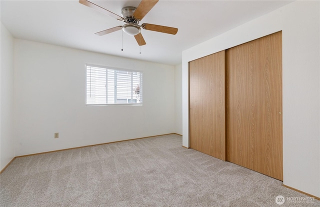 730 SE 8th Ave Unit B101, Oak Harbor, WA 98277 - unfurnished bedroom with carpet floors, a closet, baseboards, and a ceiling fan