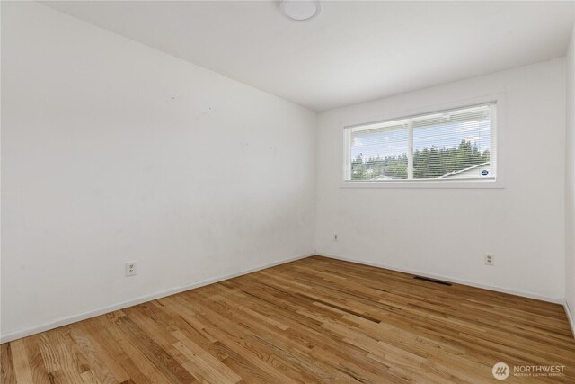 1020 SW Bowmer St, Oak Harbor, WA 98277 - empty room with wood finished floors and baseboards