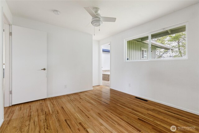 1020 SW Bowmer St, Oak Harbor, WA 98277 - unfurnished room featuring light wood-type flooring, a smoke detector, baseboards, and a ceiling fan