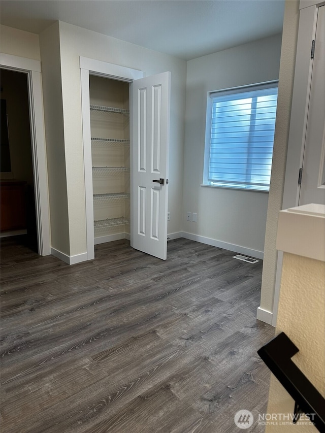 9614 191st Street Ct E, Puyallup, WA 98375 - unfurnished bedroom with dark wood-type flooring, baseboards, and a closet