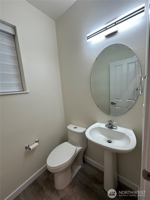 9614 191st Street Ct E, Puyallup, WA 98375 - half bathroom with wood finished floors, toilet, and baseboards