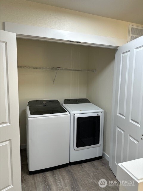 9614 191st Street Ct E, Puyallup, WA 98375 - laundry room featuring washing machine and dryer and wood finished floors