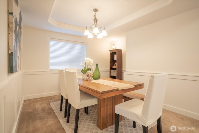 725 N 198th St, Shoreline, WA 98133 - dining area with a chandelier, a tray ceiling, light colored carpet, crown molding, and a decorative wall