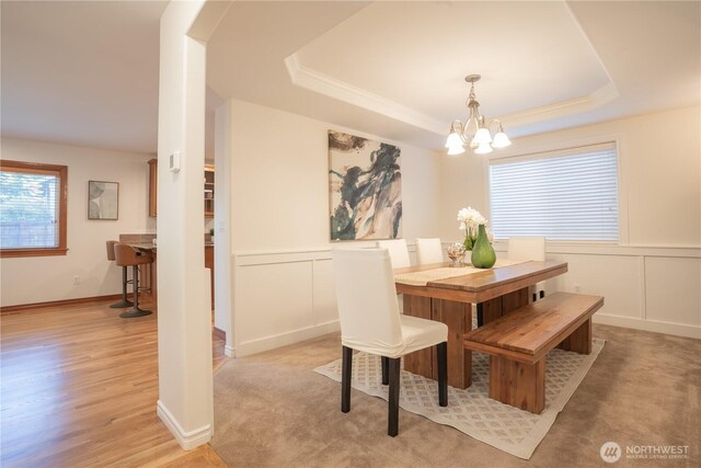 725 N 198th St, Shoreline, WA 98133 - dining room featuring a decorative wall, a chandelier, a raised ceiling, wainscoting, and light wood finished floors
