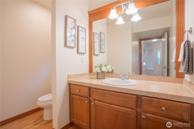 725 N 198th St, Shoreline, WA 98133 - bathroom featuring toilet, vanity, wood finished floors, and baseboards