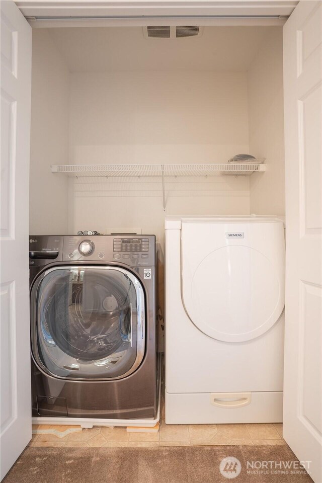 725 N 198th St, Shoreline, WA 98133 - washroom featuring washing machine and clothes dryer and tile patterned floors