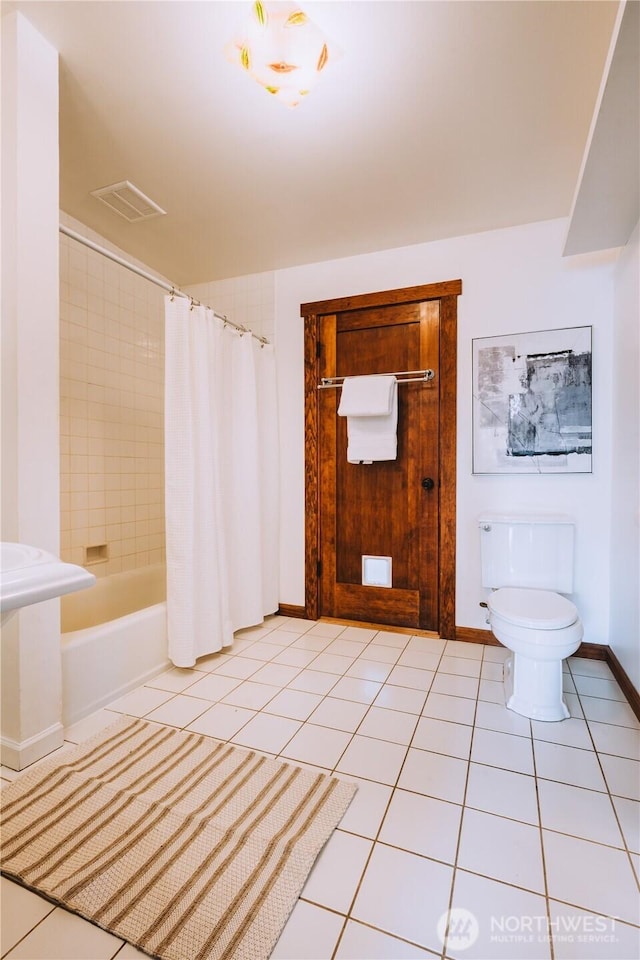 9202 3rd Ave NW, Seattle, WA 98117 - bathroom with toilet, tile patterned flooring, shower / tub combo, and baseboards