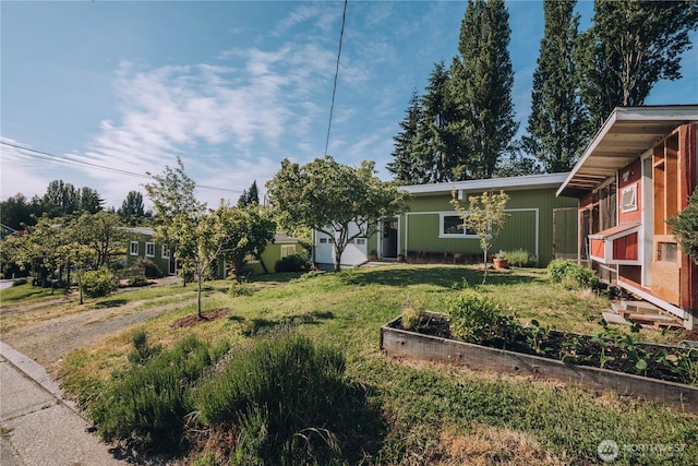 9202 3rd Ave NW, Seattle, WA 98117 - view of front of property with a vegetable garden and a front lawn