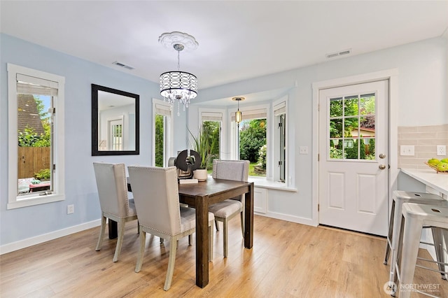 22718 1st Pl W, Bothell, WA 98021 - dining room with a chandelier, light wood finished floors, and baseboards