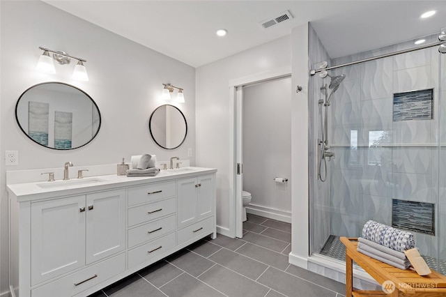 22718 1st Pl W, Bothell, WA 98021 - bathroom with a shower stall, double vanity, toilet, tile patterned floors, and recessed lighting