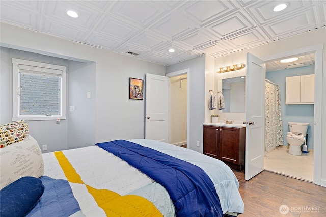 22718 1st Pl W, Bothell, WA 98021 - bedroom with recessed lighting, wood finished floors, ensuite bath, an ornate ceiling, and a sink