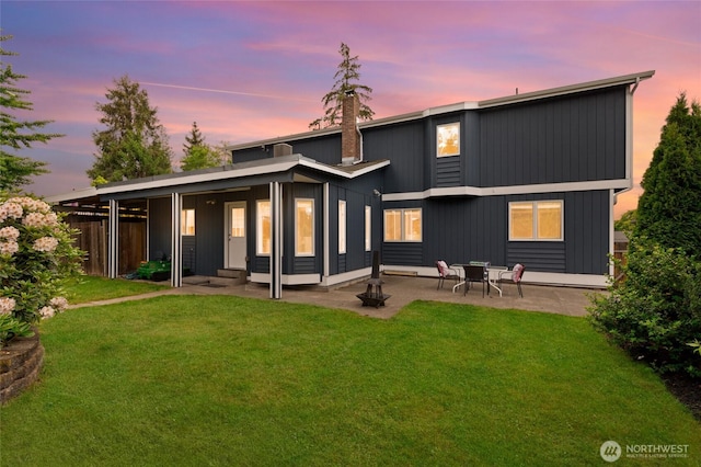 22718 1st Pl W, Bothell, WA 98021 - back of property at dusk featuring a lawn and a patio