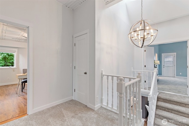 22718 1st Pl W, Bothell, WA 98021 - hall with an upstairs landing, a chandelier, carpet flooring, baseboards, and a towering ceiling