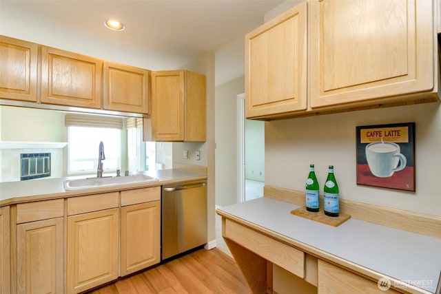 1526 Alki Ave SW Unit 303, Seattle, WA 98116 - kitchen featuring a sink, stainless steel dishwasher, light brown cabinets, light wood-style floors, and light countertops