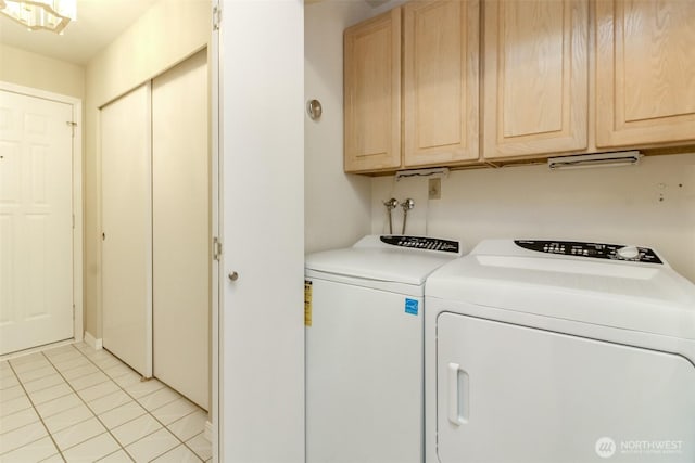1526 Alki Ave SW Unit 303, Seattle, WA 98116 - laundry area featuring cabinet space, separate washer and dryer, and light tile patterned flooring