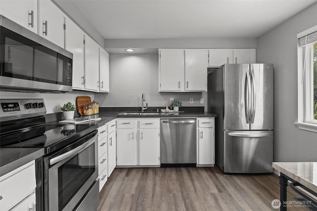 11620 28th St NE, Lake Stevens, WA 98258 - kitchen with appliances with stainless steel finishes, recessed lighting, dark wood-type flooring, white cabinetry, and dark countertops