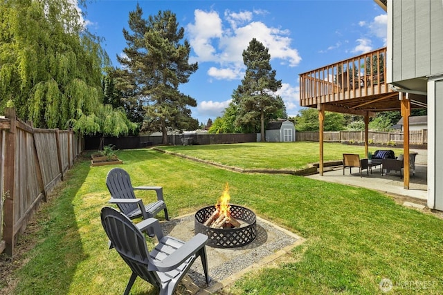 11620 28th St NE, Lake Stevens, WA 98258 - fenced backyard with a fire pit, a storage shed, a patio, and a wooden deck