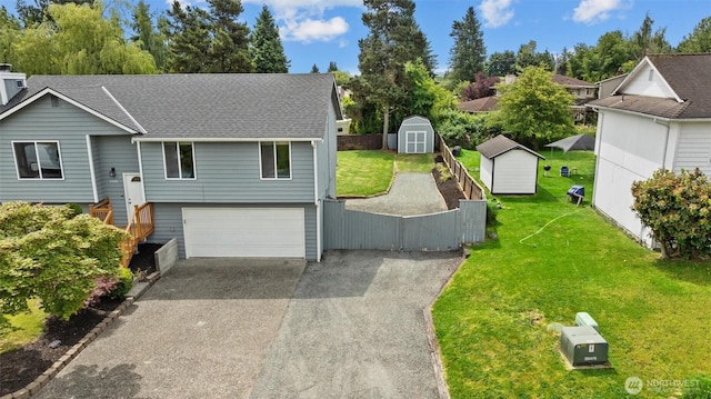 11620 28th St NE, Lake Stevens, WA 98258 - view of front of home with a storage shed, asphalt driveway, a garage, and a shingled roof