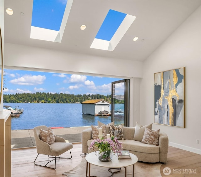8620 N Mercer Way, Mercer Island, WA 98040 - living room featuring a skylight, wood finished floors, a water view, high vaulted ceiling, and recessed lighting
