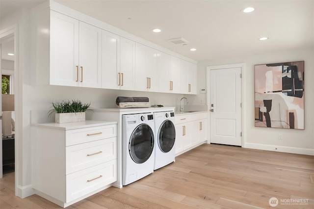 8620 N Mercer Way, Mercer Island, WA 98040 - laundry area featuring separate washer and dryer, light wood-style flooring, cabinet space, and recessed lighting