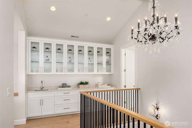 8620 N Mercer Way, Mercer Island, WA 98040 - bar featuring a sink, light wood-style flooring, recessed lighting, and a chandelier