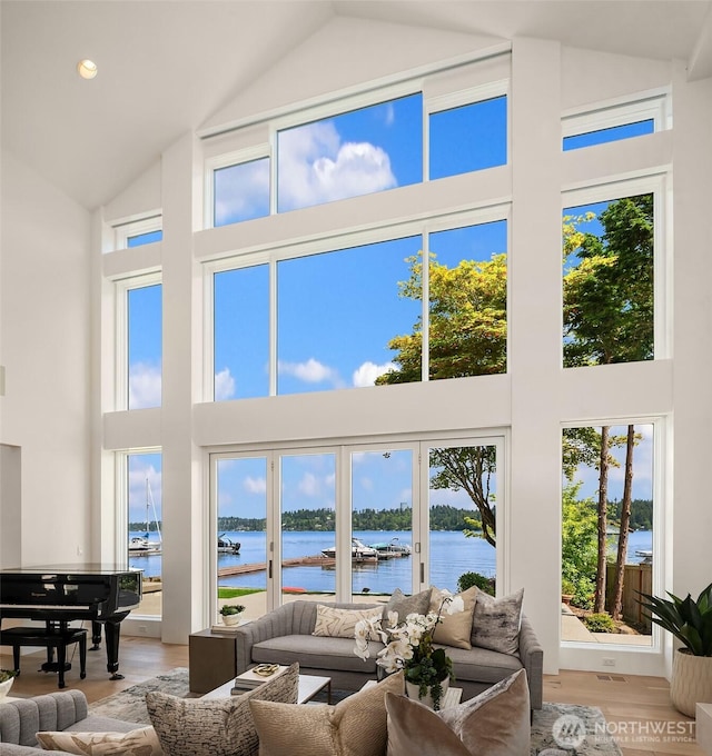 8620 N Mercer Way, Mercer Island, WA 98040 - living room with high vaulted ceiling, a water view, and light wood-style floors