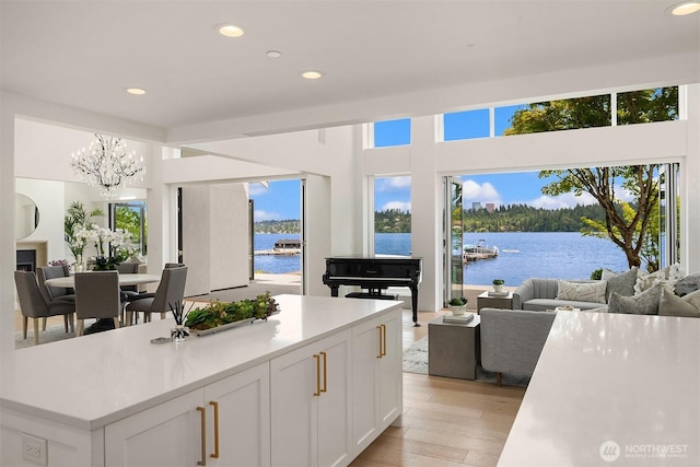 8620 N Mercer Way, Mercer Island, WA 98040 - kitchen with open floor plan, a water view, recessed lighting, and a chandelier