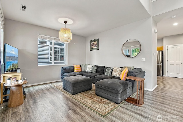 6499 Francis Loop SE, Auburn, WA 98092 - living area featuring baseboards, wood finished floors, and recessed lighting