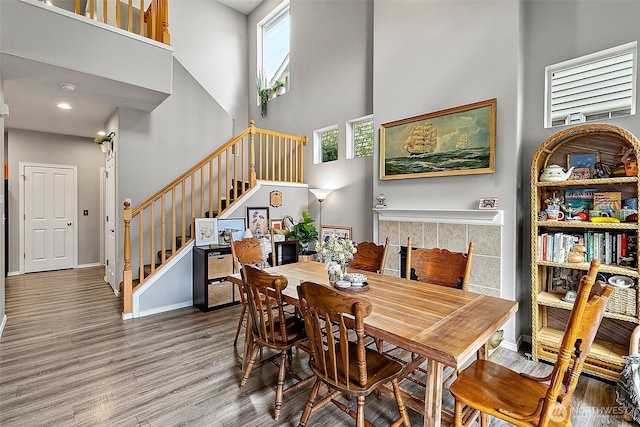 6499 Francis Loop SE, Auburn, WA 98092 - dining area featuring wood finished floors, stairway, a towering ceiling, and baseboards