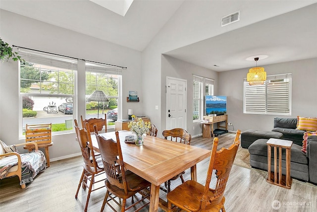 6499 Francis Loop SE, Auburn, WA 98092 - dining area with light wood-type flooring, healthy amount of natural light, high vaulted ceiling, and baseboards