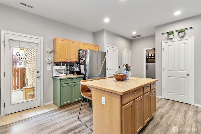 6499 Francis Loop SE, Auburn, WA 98092 - kitchen with freestanding refrigerator, light wood-type flooring, tile countertops, green cabinetry, and recessed lighting