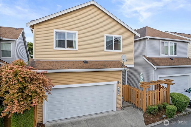 6499 Francis Loop SE, Auburn, WA 98092 - view of front of property with an attached garage, driveway, and a shingled roof