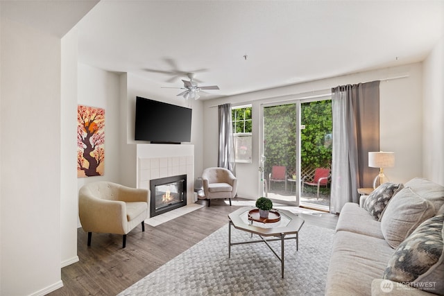 2300 Benson Rd S Unit D3, Renton, WA 98055 - living room featuring a fireplace, wood finished floors, ceiling fan, and baseboards