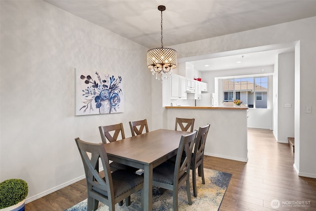 2300 Benson Rd S Unit D3, Renton, WA 98055 - dining room with dark wood-style floors, a chandelier, and baseboards