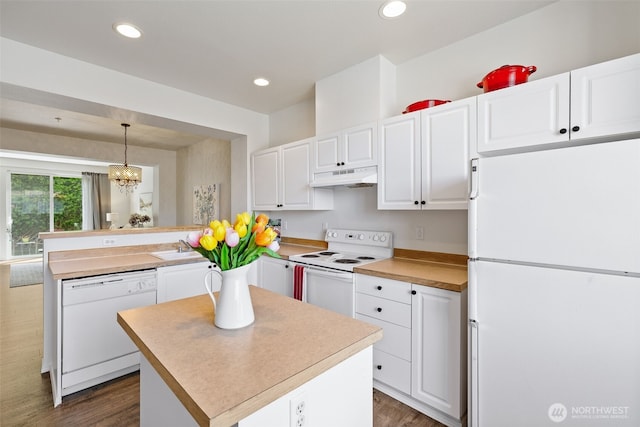 2300 Benson Rd S Unit D3, Renton, WA 98055 - kitchen with white appliances, under cabinet range hood, a peninsula, dark wood-type flooring, and white cabinets