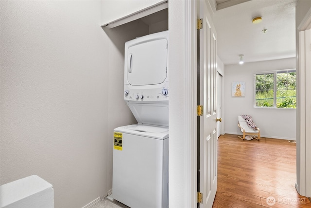 2300 Benson Rd S Unit D3, Renton, WA 98055 - laundry area with estacked washer and dryer, light wood-style floors, and baseboards