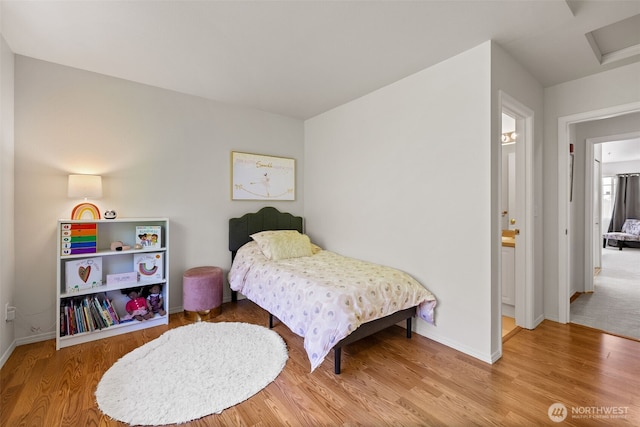 2300 Benson Rd S Unit D3, Renton, WA 98055 - bedroom featuring wood finished floors, baseboards, and attic access