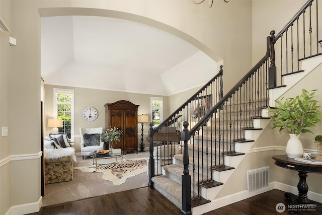 21505 30th Ave SE, Bothell, WA 98021 - entrance foyer featuring arched walkways, wood finished floors, stairs, baseboards, and high vaulted ceiling