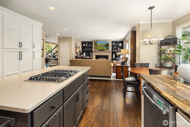 21505 30th Ave SE, Bothell, WA 98021 - kitchen with stainless steel appliances, white cabinets, dark wood-style flooring, a fireplace, and recessed lighting