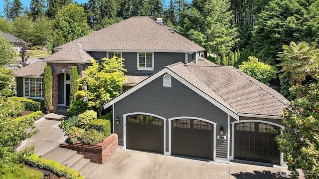 21505 30th Ave SE, Bothell, WA 98021 - view of front facade featuring roof with shingles, a garage, and driveway