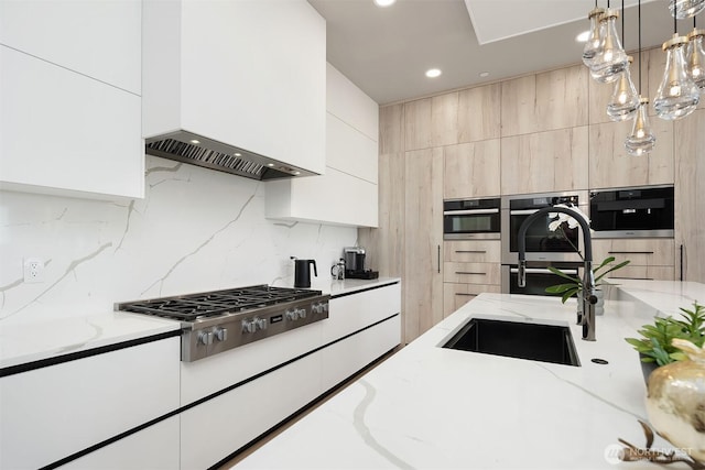 17281 SE 43rd St, Bellevue, WA 98006 - kitchen with custom exhaust hood, modern cabinets, stainless steel gas stovetop, backsplash, and recessed lighting