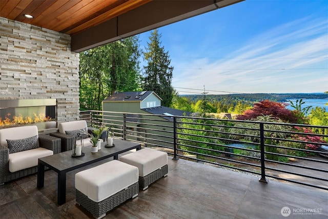 17281 SE 43rd St, Bellevue, WA 98006 - view of patio / terrace with an outdoor stone fireplace and a balcony