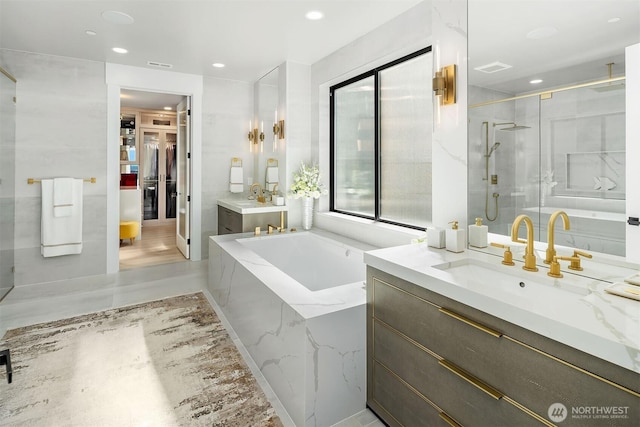 17281 SE 43rd St, Bellevue, WA 98006 - bathroom featuring a stall shower, vanity, a bath, and recessed lighting